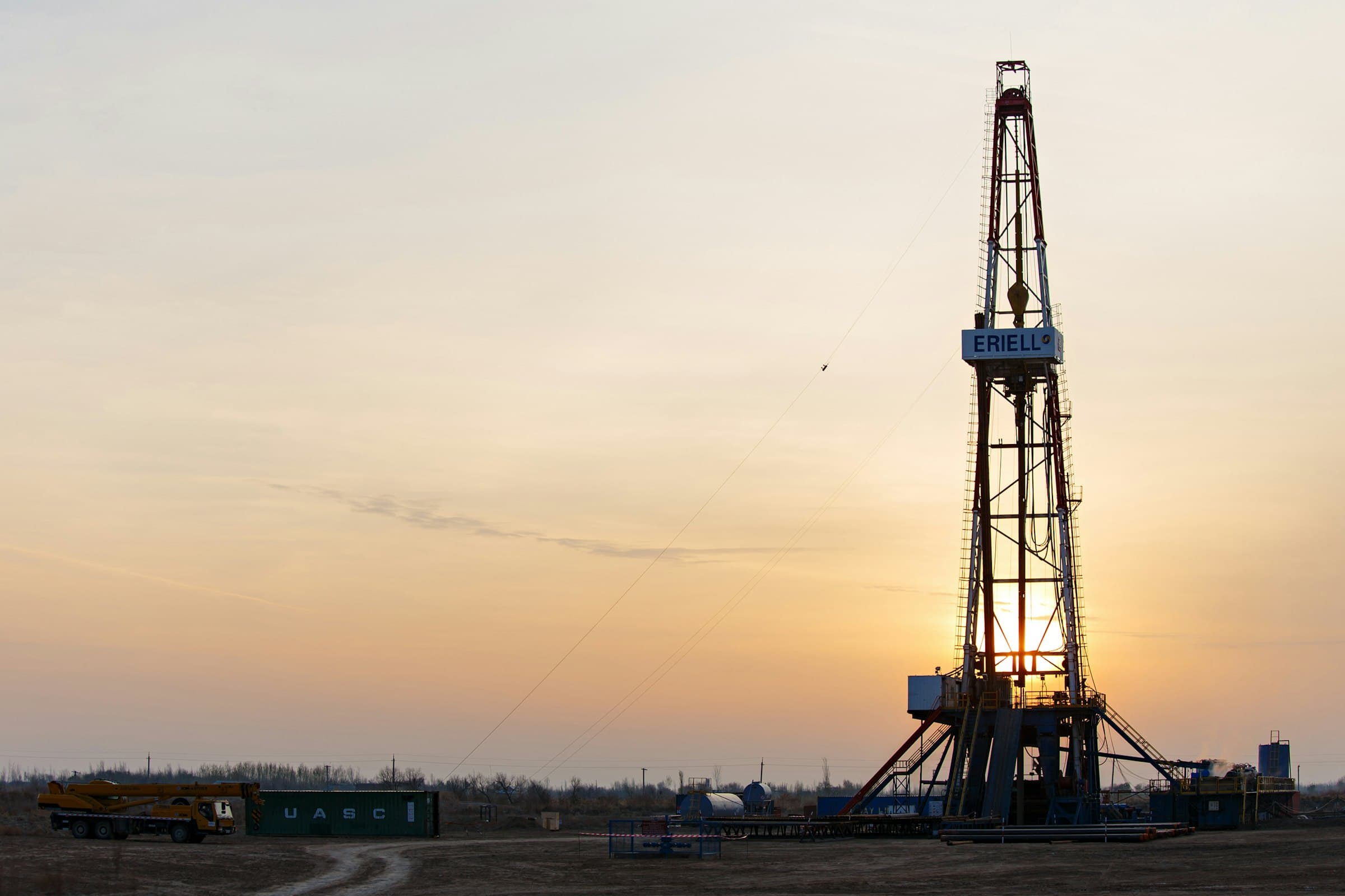 Land drilling rig and site equipment at golden hour